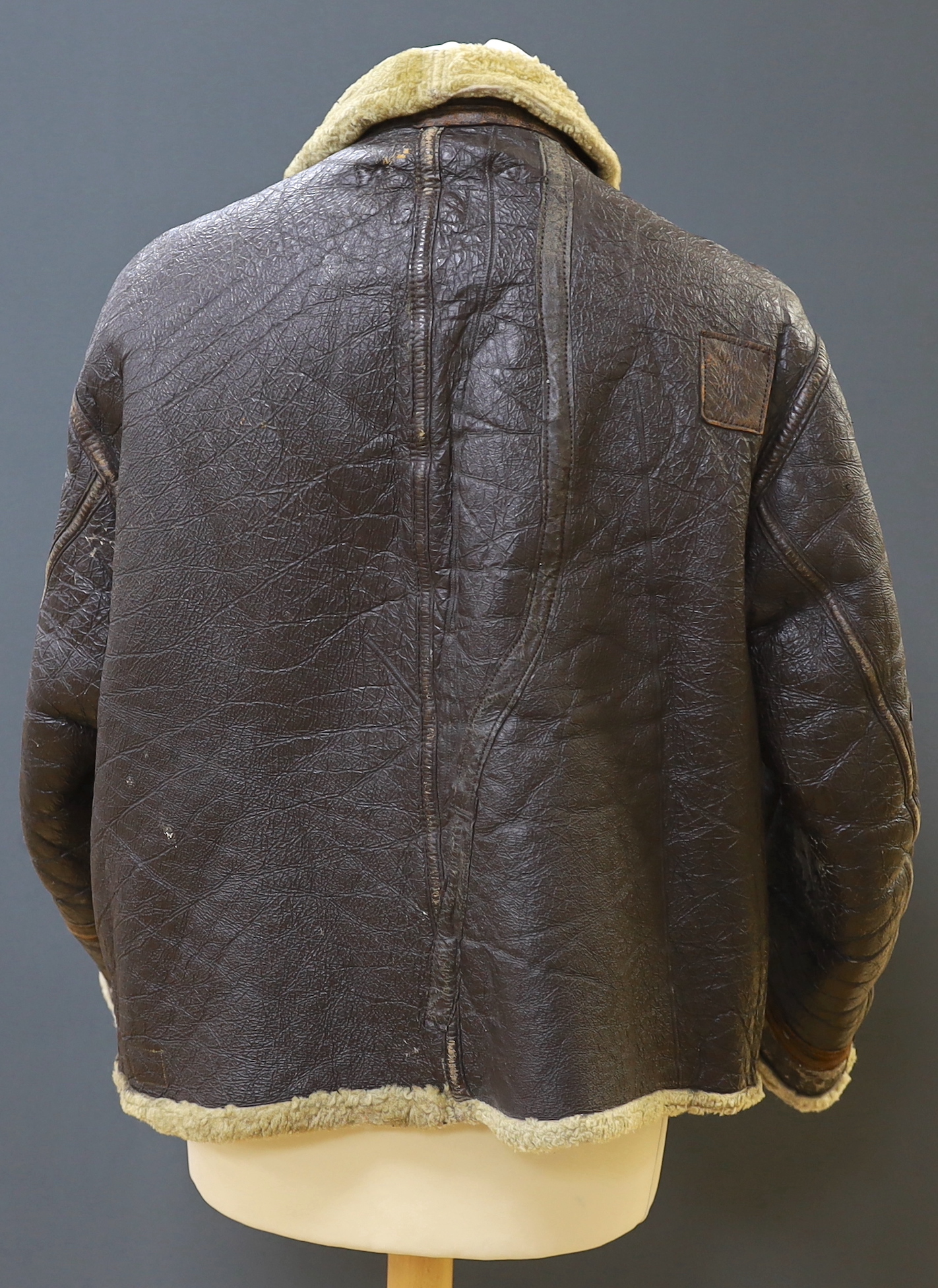 An American US Air Force sheepskin flying jacket, with applied label in collar reading ‘TYPE ….. SIZE MEDIUM SPEC NO. 94-3084 ORDER NO 42-12685-P PROPERTY AIR FORCE U.S. ARMY H. BERNSTEIN & CO.’